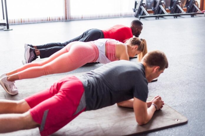 A picture containing group of people engage in physical exercises